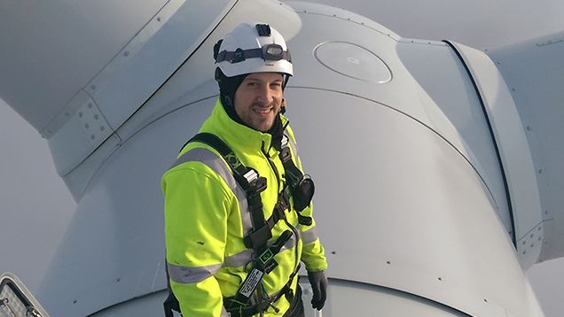 Service technician at the top of an offshore wind turbine